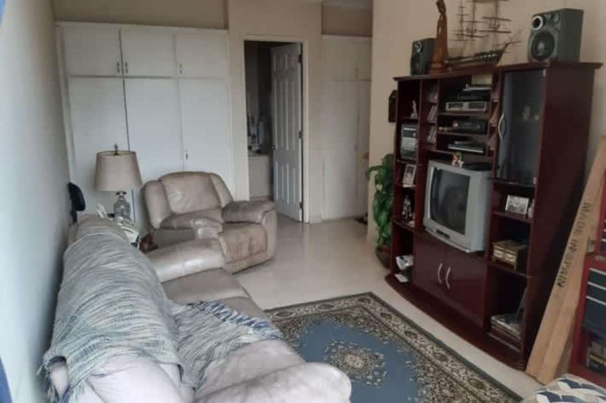 Bright living room with marble floors and entertainment unit at PH El Cangrejo Residences Panama