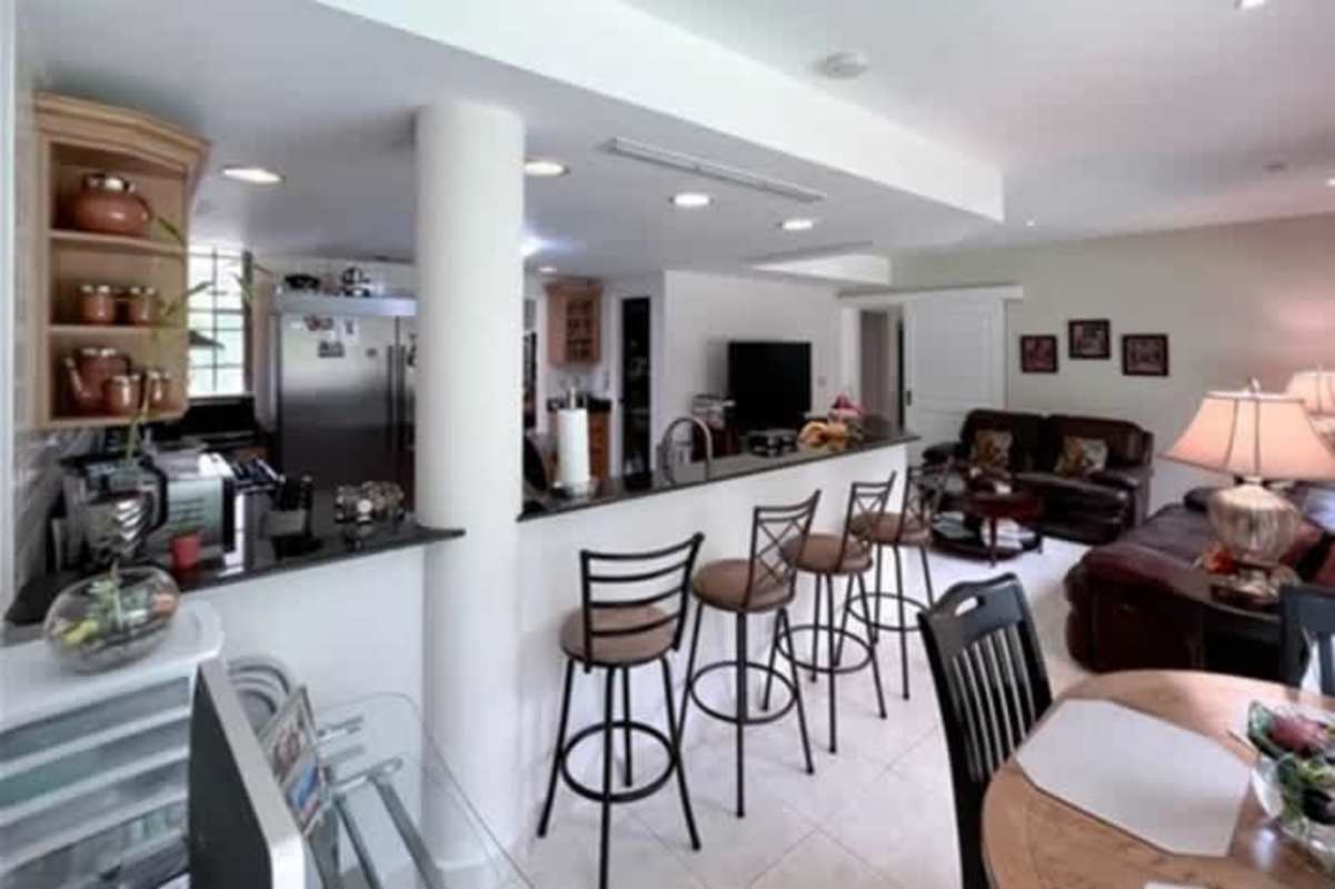 Spacious living area with ceiling fans, large balcony, modern furnishings at Cardenas Village Clayton home Panama