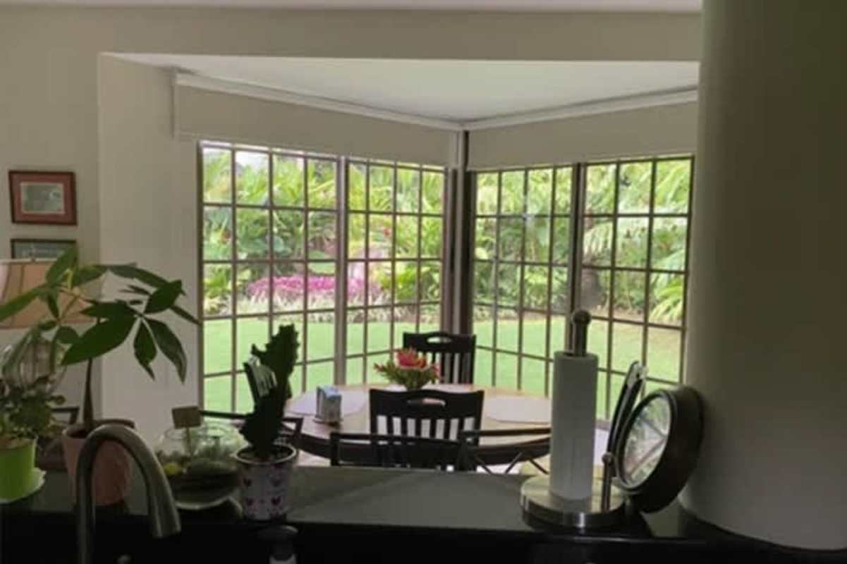 Large master bedroom with private balcony, seating area, tile floors at Cardenas Village Clayton Panama