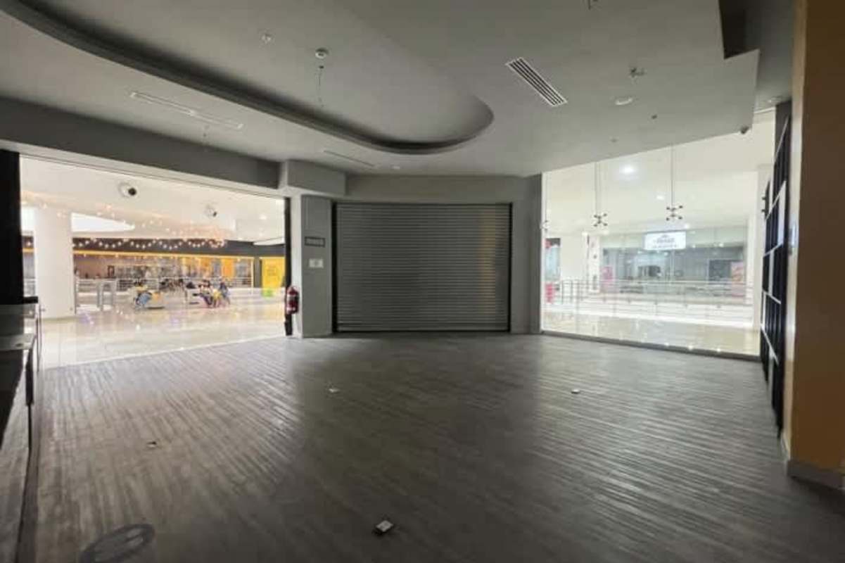 Simple tiled bathroom with toilet sink mirror for commercial shop at Los Andes Mall