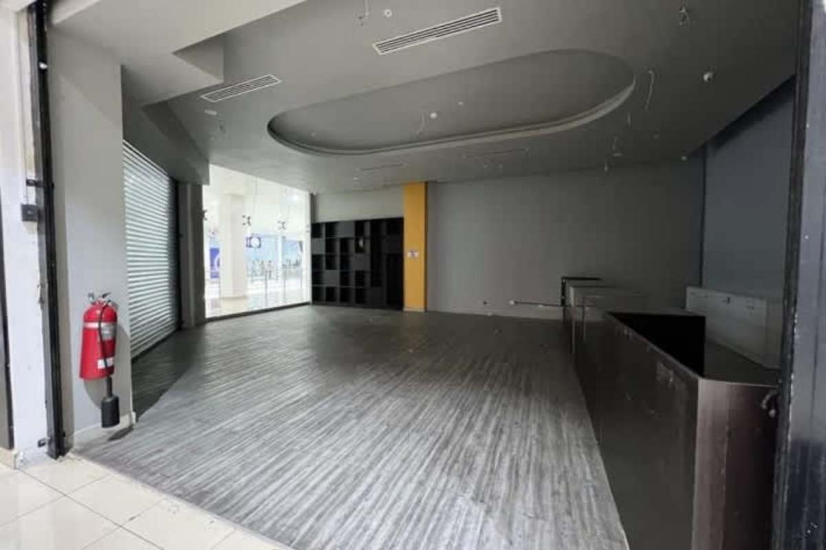Spacious commercial interior with glass store windows and tiled floors in Los Andes Mall Panama