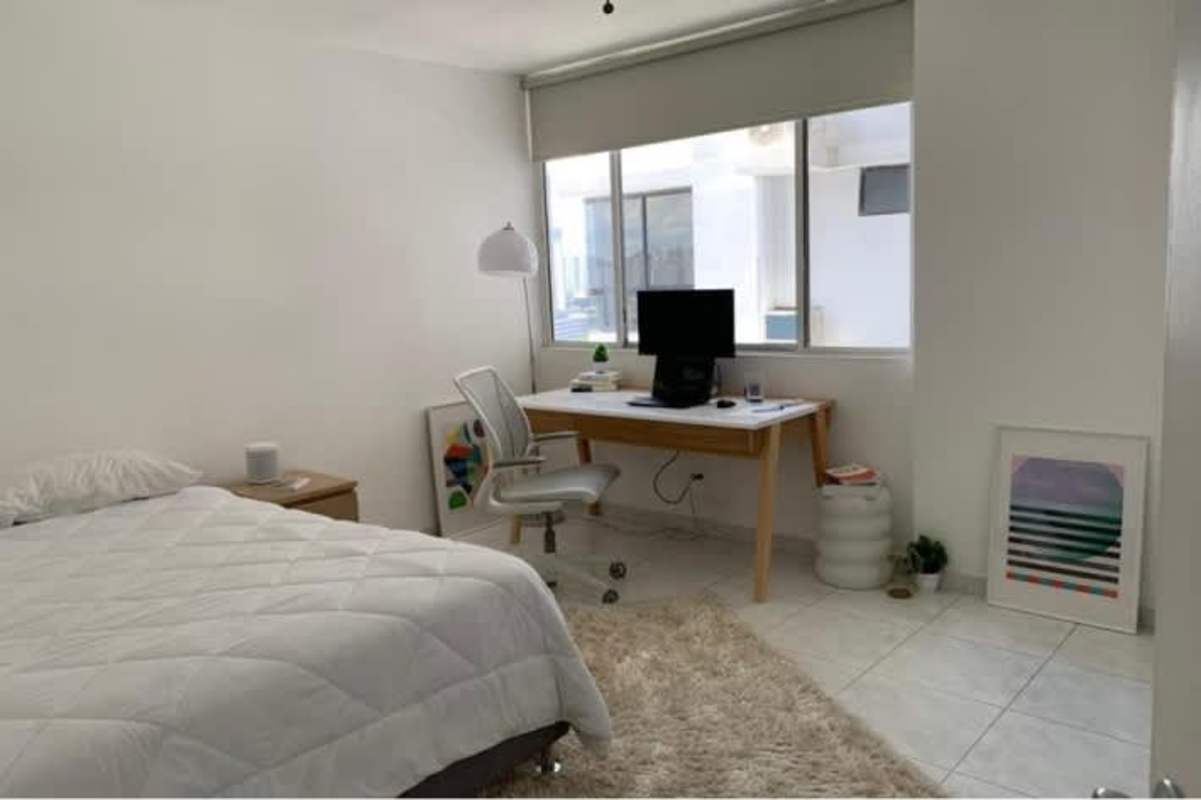 Spacious bedroom with large windows facing ocean skyline at PH BICSA Panama City