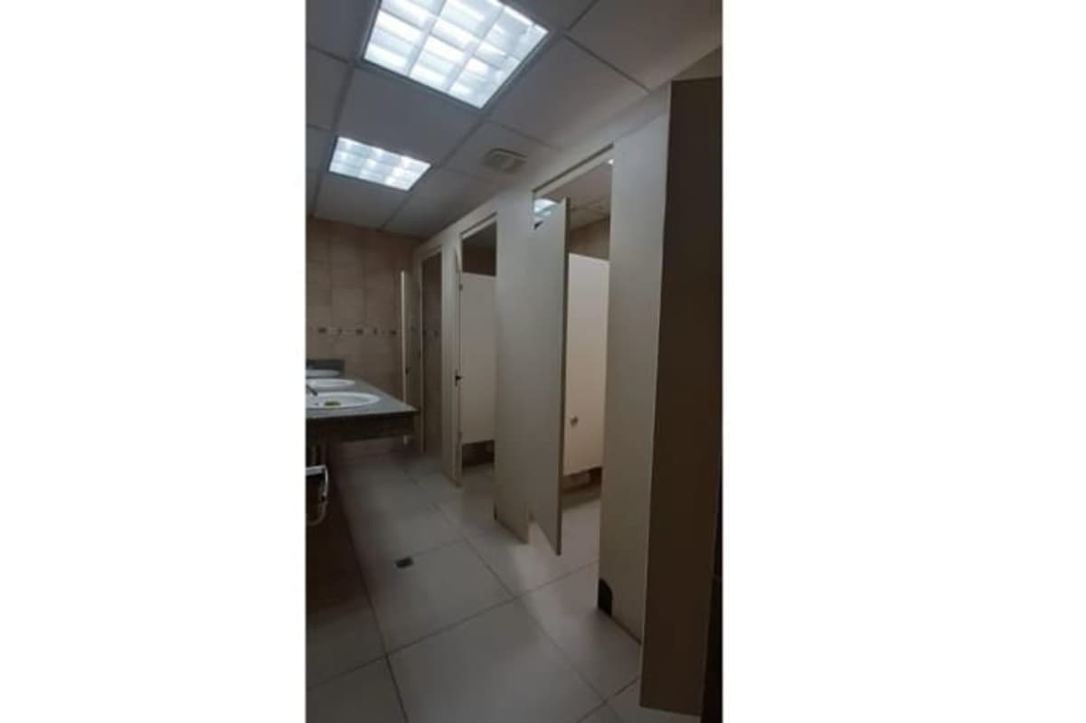 Commercial restroom with double sinks and private stalls at PH El Cangrejo Business Center Panama City