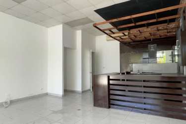 Modern multi-story resort complex with balconies and palm trees in Playa Blanca