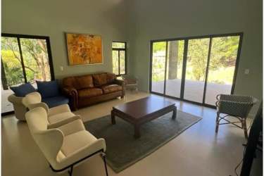 Open living space with large sliding doors, garden views, and high ceilings at Altos del María Panama