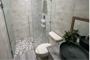 Contemporary bathroom with vessel sink, glass walk-in shower and neutral tiles in mountain house Panama