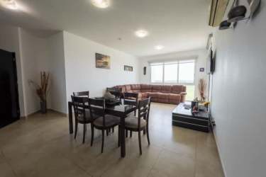 Furnished master bedroom with king bed and ocean view window Playa Blanca condo for rent Panama