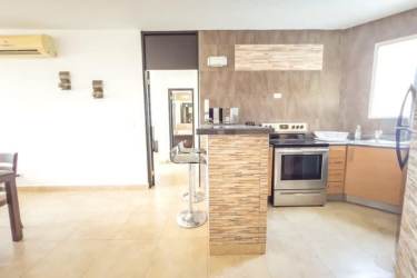 Covered balcony with outdoor dining set and pool ocean view Playa Blanca Resort condo