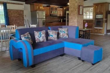 Dining room with wood dining table open to living in Coronado beach house Panama