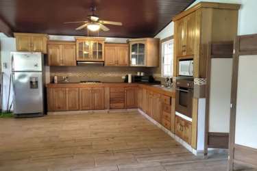 Bedroom with brick accent wall and AC unit in rustic Coronado beach house Panama