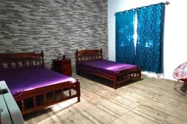 Bathroom with blue decorative tiles, glass shower enclosure in Coronado beachfront home Panama