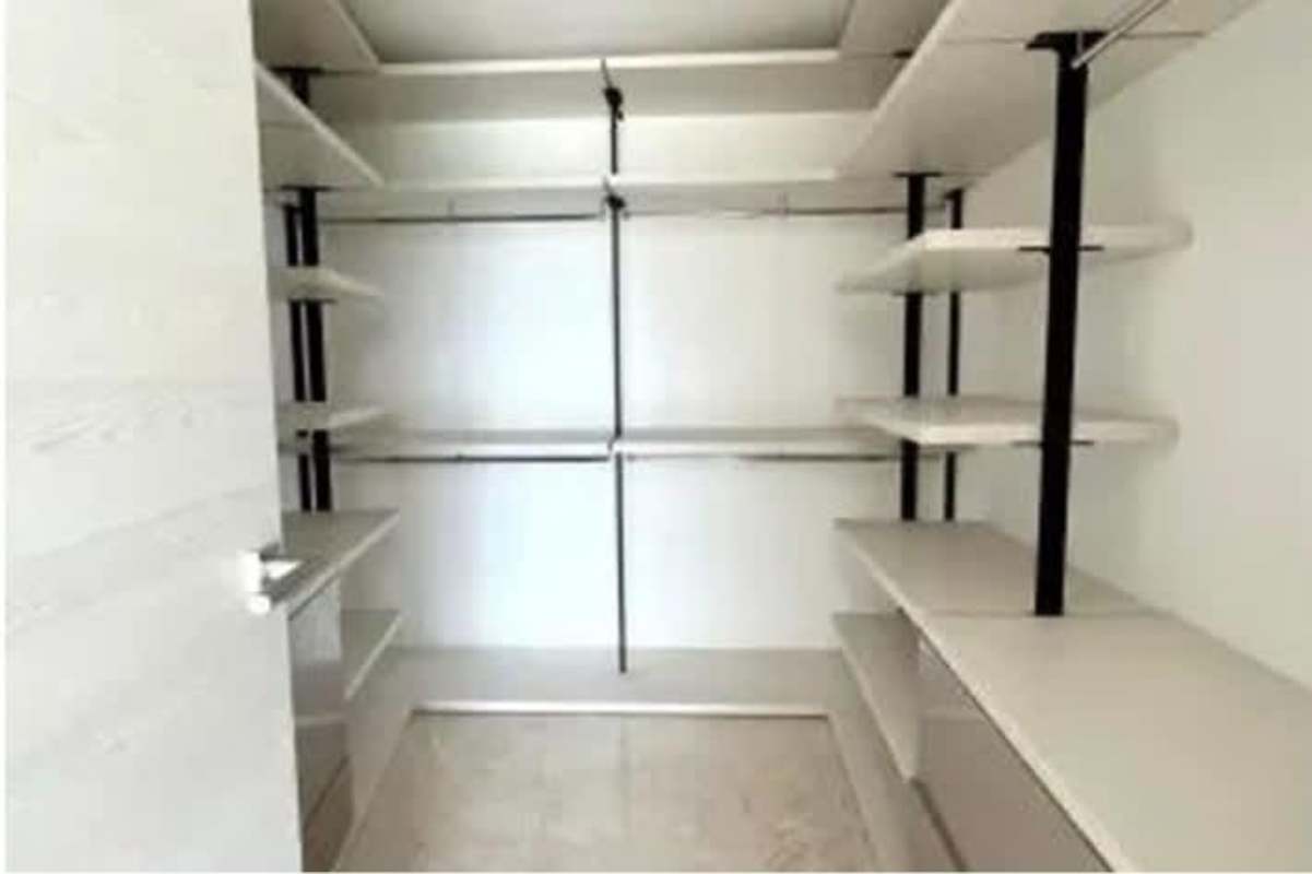 Spacious walk-in closet with built-in shelves minimalist design Santa Maria Golf Country Panama City