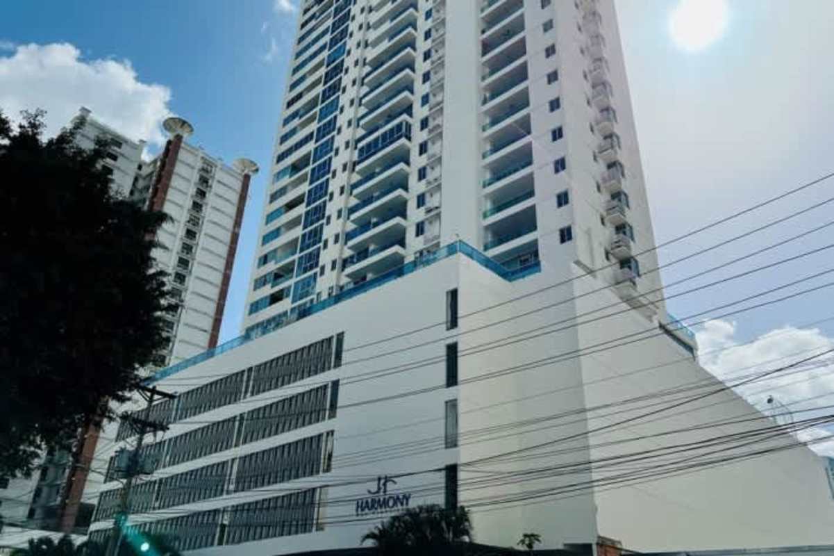 Exterior view of PH Harmony Tower modern high-rise apartment with balconies and glass windows in Panama City