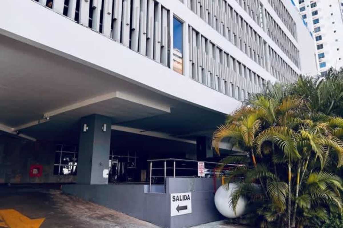 Gym with large windows overlooking skyline equipped with treadmill and fitness gear at Harmony Tower Panama