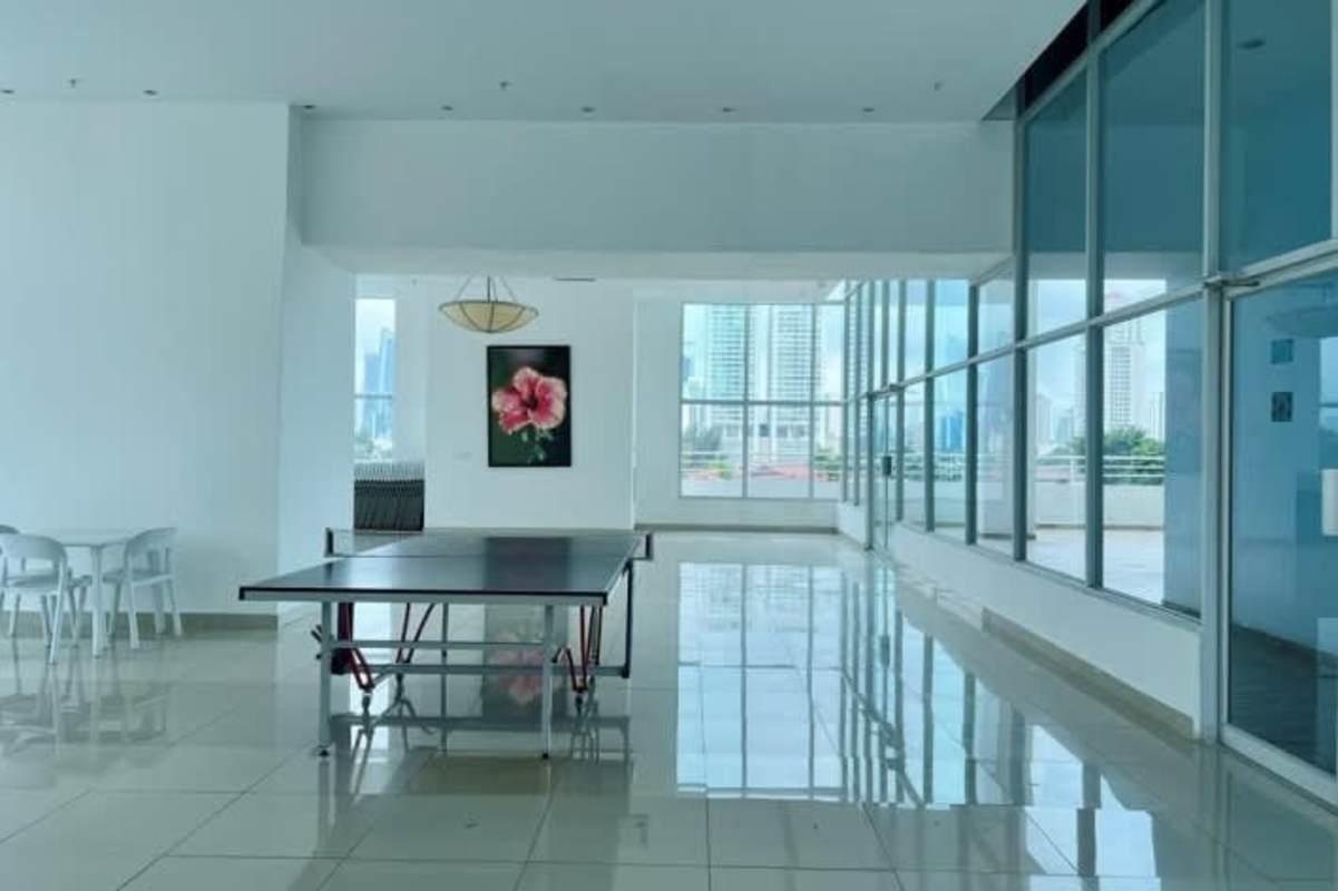 Modern indoor recreation room with ping pong table floor-to-ceiling windows city view Harmony Tower
