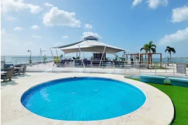 Infinity pool with sun loungers overlooking Pacific Ocean at Ocean Waves Nueva Gorgona