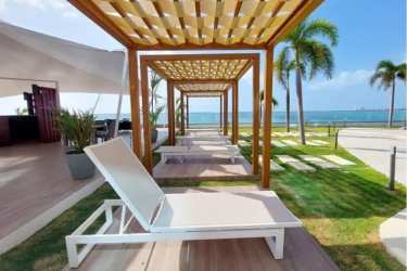 Coastal modern outdoor lounge with ocean view and pergolas at Ocean Waves Nueva Gorgona Panama