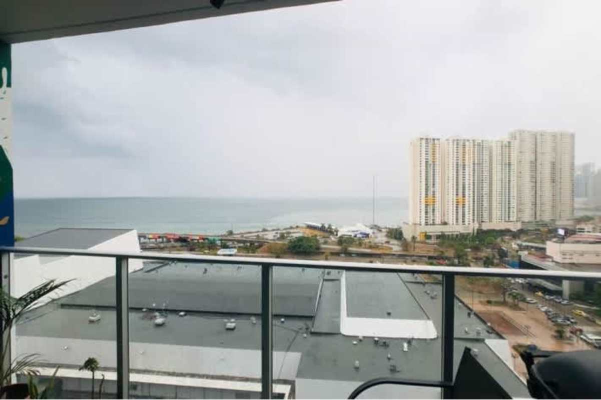 Modern balcony with glass railing overlooking ocean and high-rise skyline PH San Francisco Bay Panama