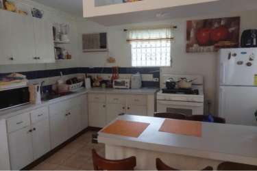 Circular swimming pool with garden and patio seating in Coronado Panama beach house