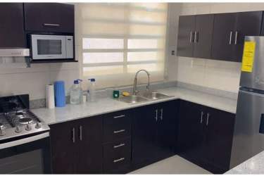 Large modern walk-in closet with built-in shelves and drawers in Nueva Gorgona beach townhouse