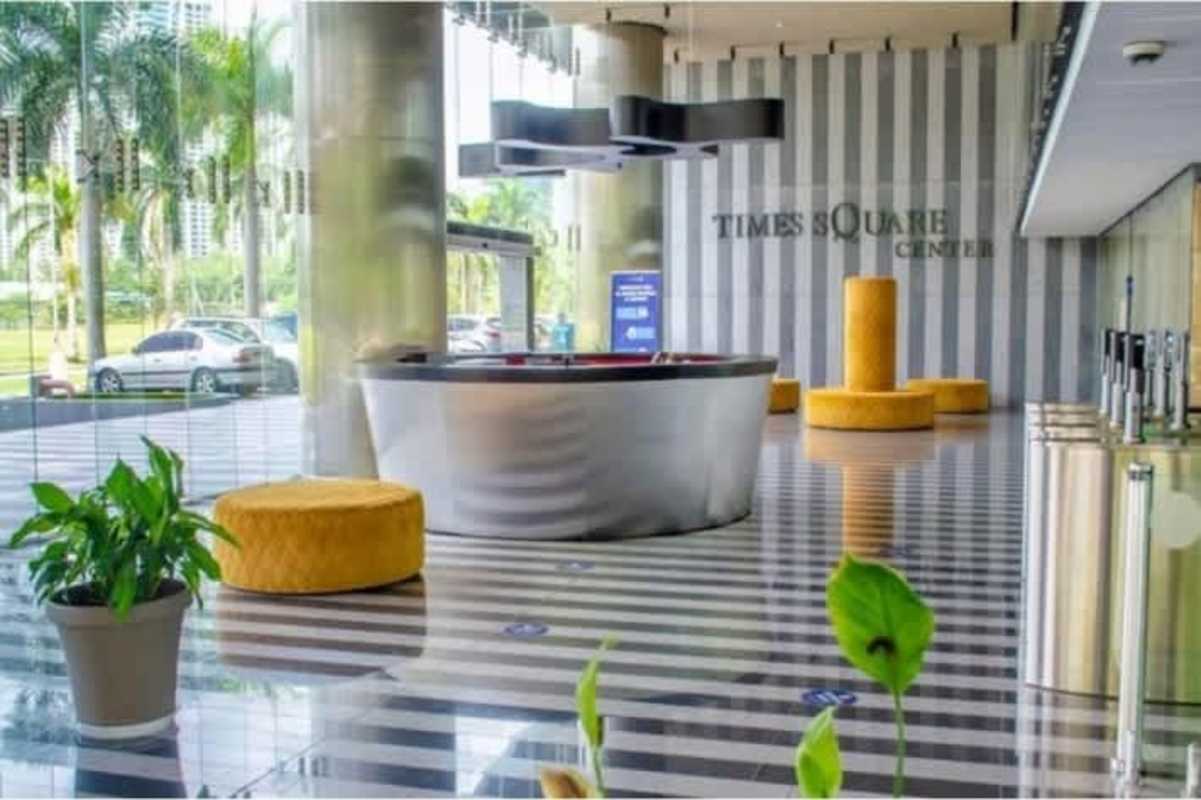 Corporate lobby featuring secure turnstiles, reflective floors, red accent wall, PH Oceania Business Plaza Panama