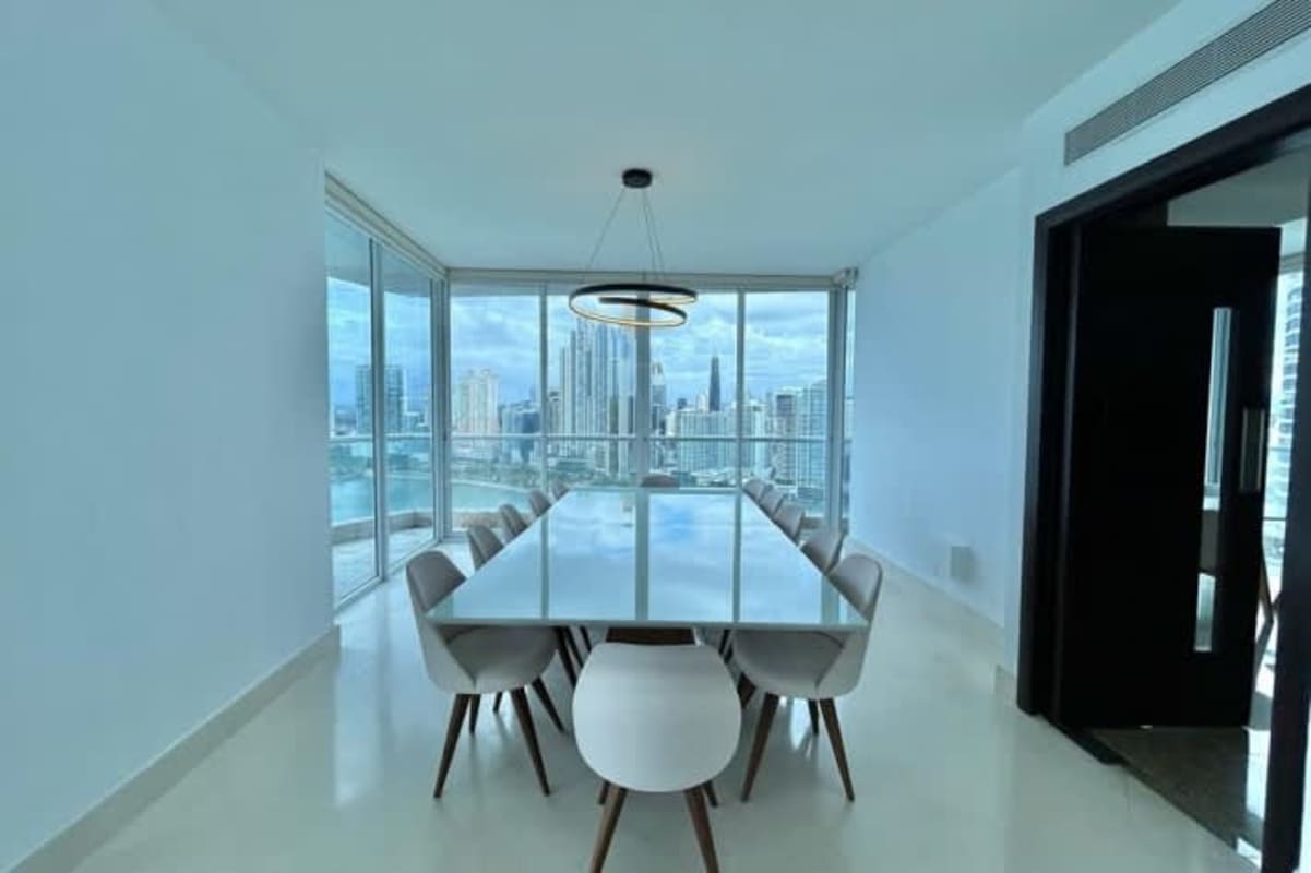 Modern open-plan living dining with panoramic windows, high ceilings PH Punta Paitilla Panama City luxury rent
