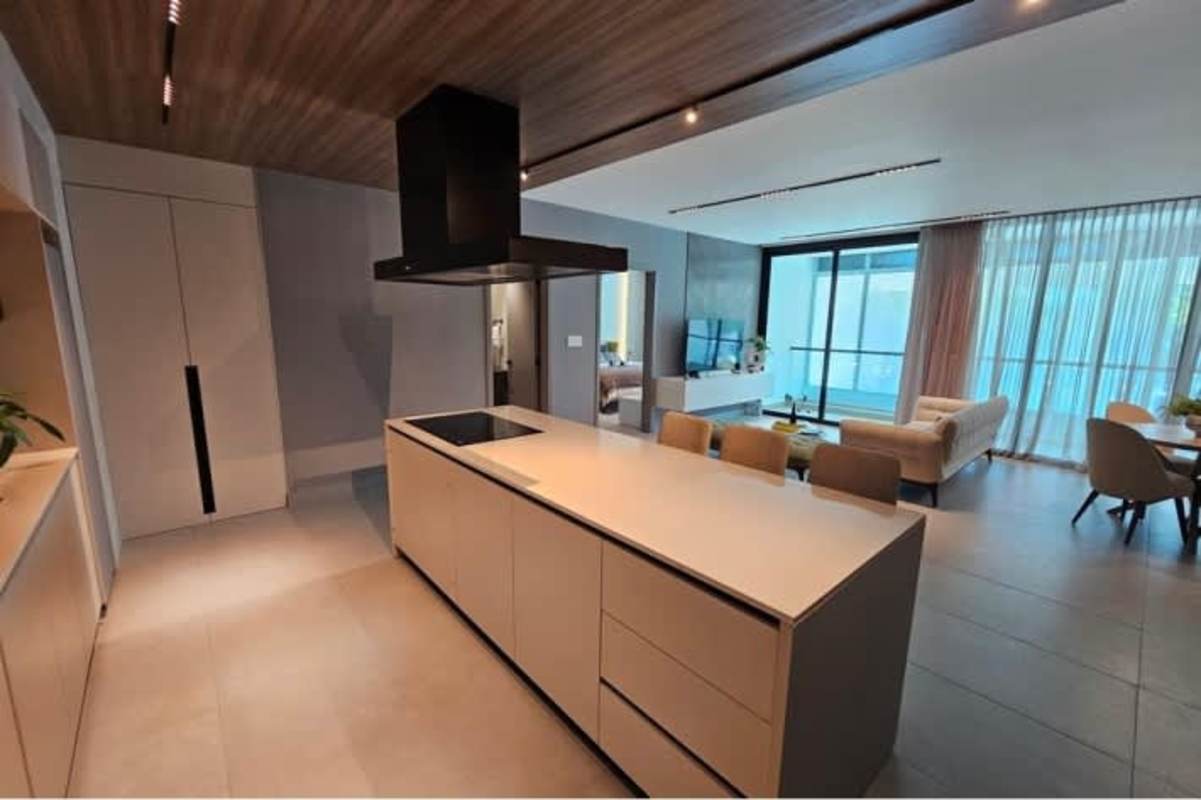 Contemporary living room with large windows, designer furnishings overlooking city views at PH MARQUEE