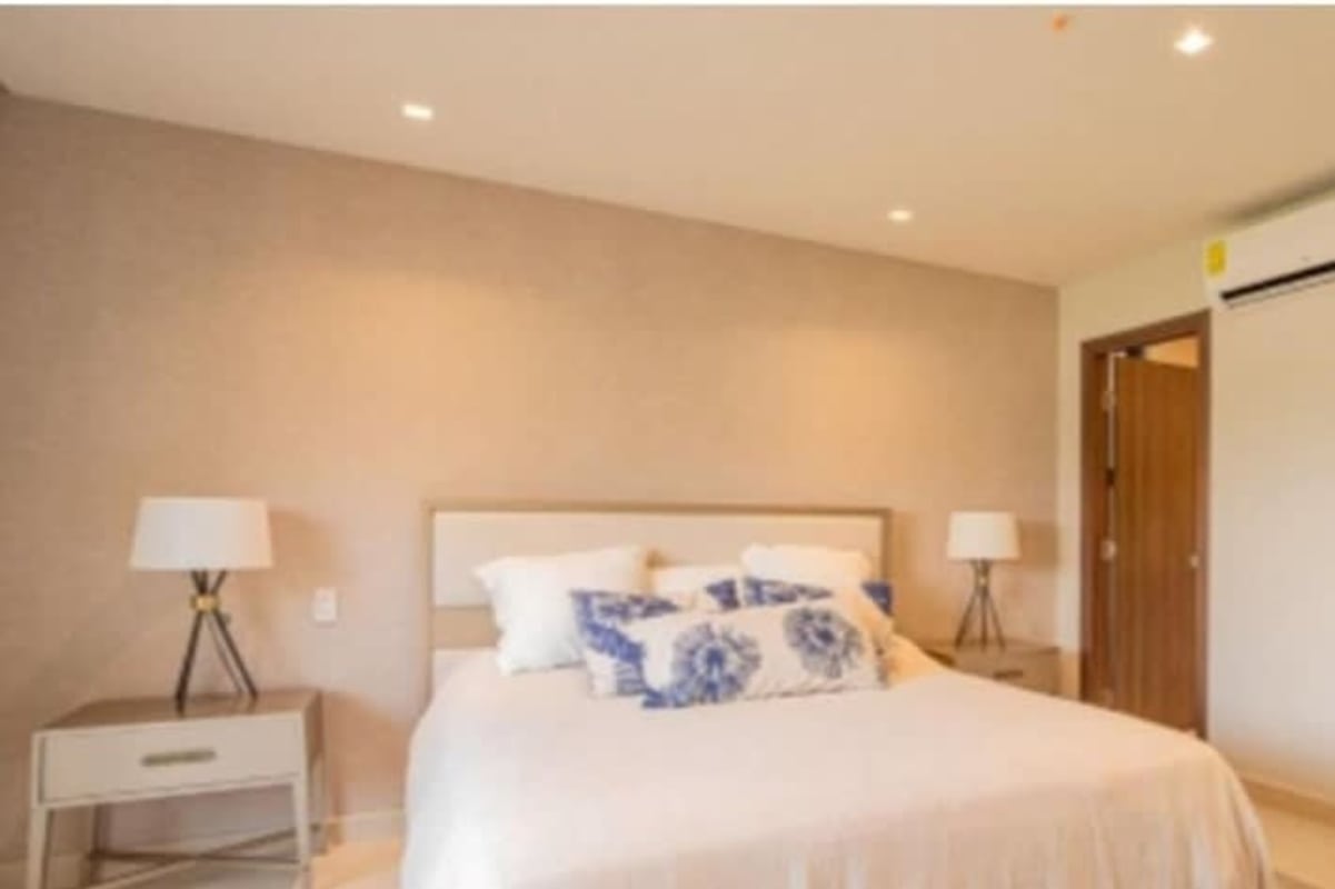 Bedroom decorated in minimalist style with ensuite bath Costa del Este Lofts Panama