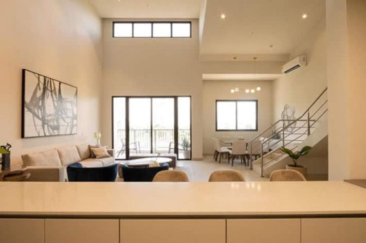 Bedroom with built-in closet and ensuite bath in Costa del Este loft Panama