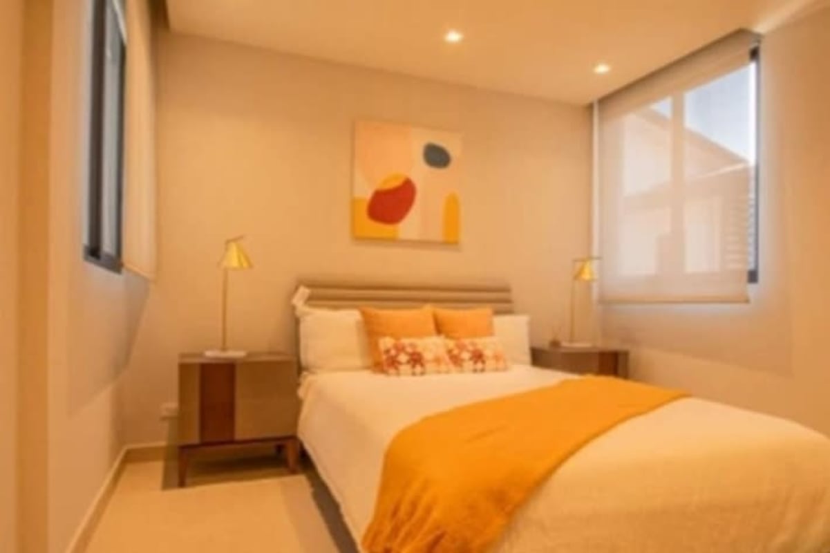 Modern open kitchen with large island and dining area in Costa del Este loft apartment Panama