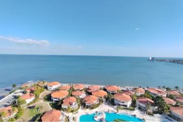 Oceanfront balcony with comfortable outdoor seating at PH Coronado Golf Coronado Panama