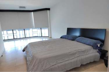 Modern minimalist bedroom with large window at PH Coronado Golf in Coronado Panama