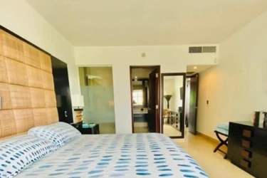 Main bedroom furnished with ocean view window, Nikki Beach Playa Blanca Panama