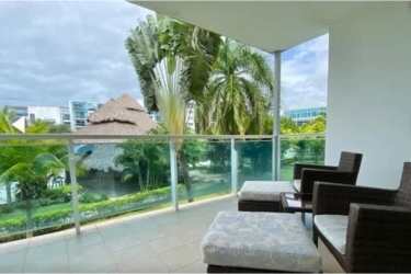 Living dining area with sectional sofa, open kitchen breakfast bar Nikki Beach Playa Blanca Panama