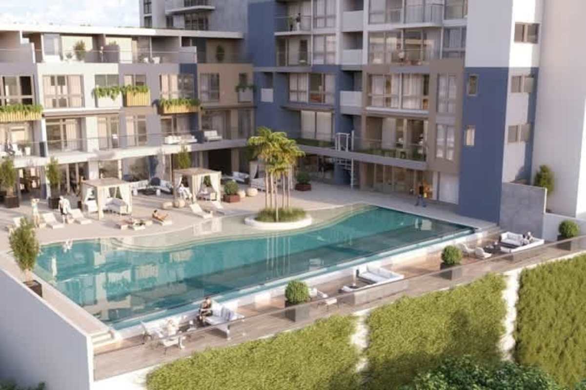 Large swimming pool with cabanas, palm trees, and lounge area Oceana Santa Maria Panama