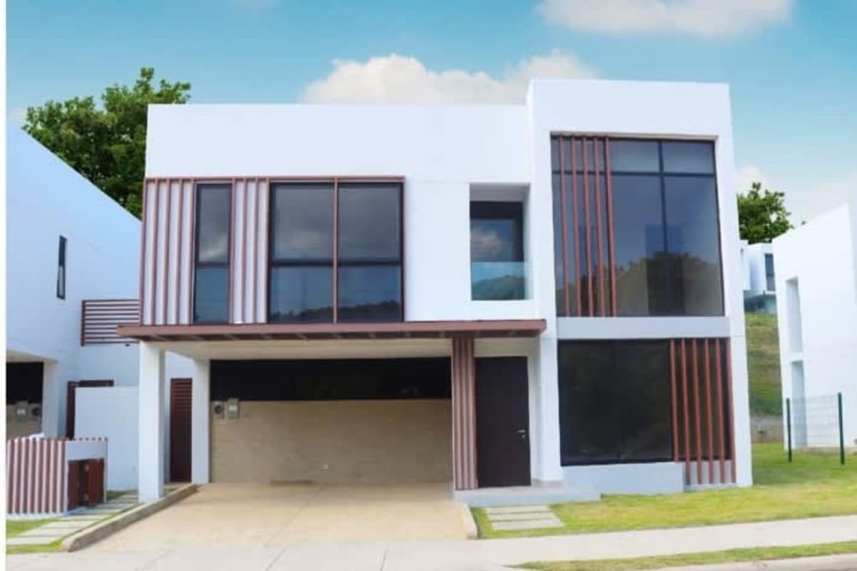 Modern open kitchen with granite island, light wood cabinets and dining area Green City Panama