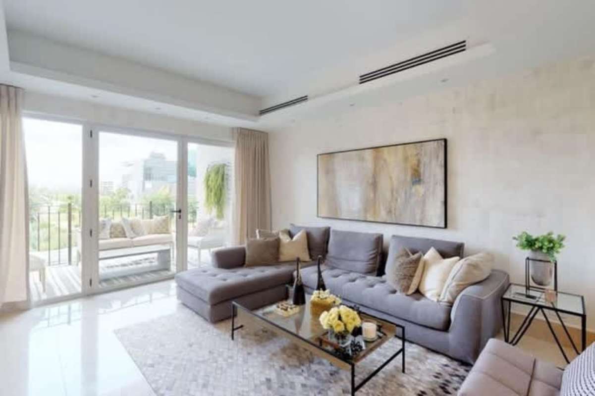 Bright living area with large balcony doors offering golf views in PH Pinnacle Tower Santa Maria Panama