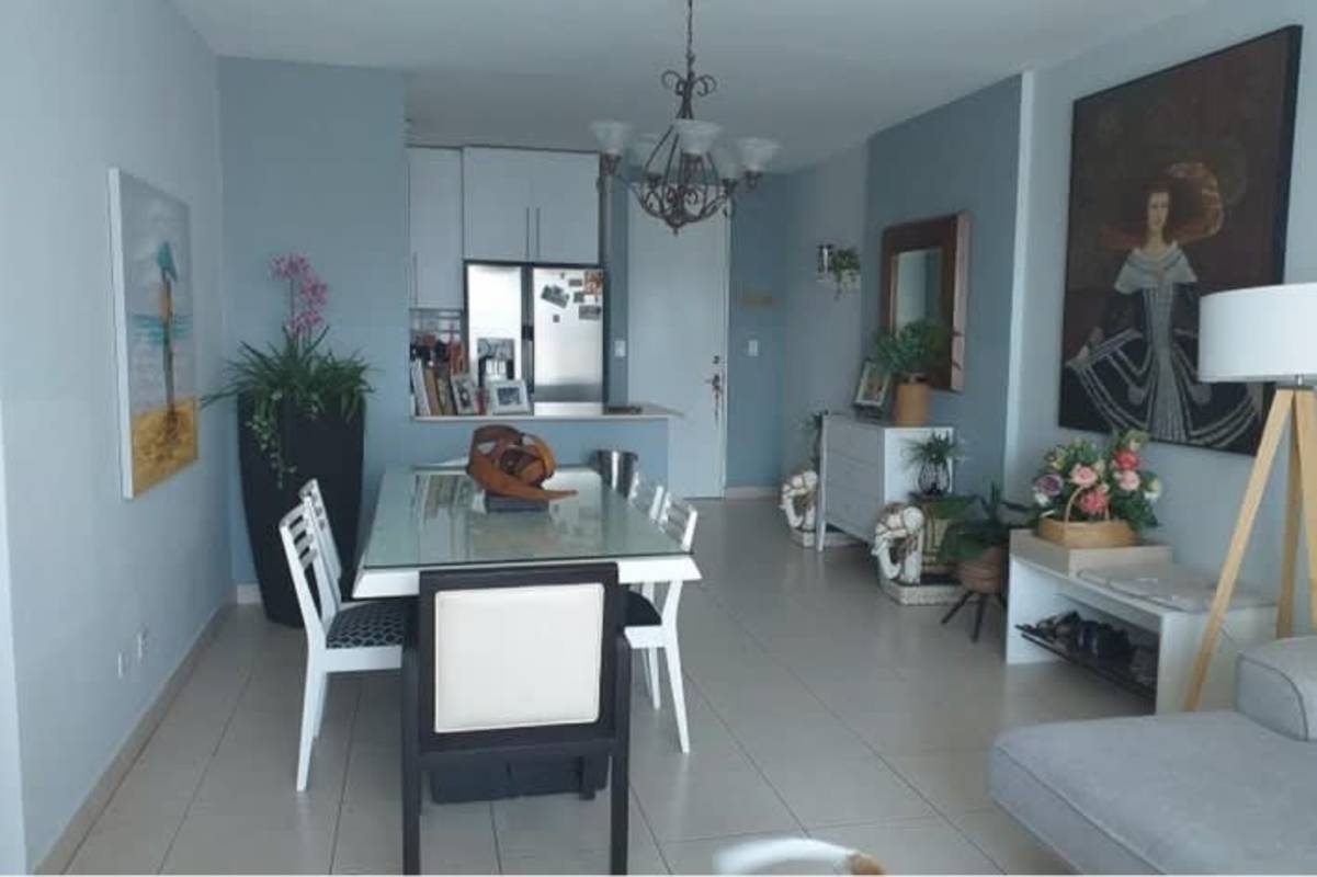 Modern living dining room with blue accent wall, chandelier and bright windows PH San Francisco Bay Panama