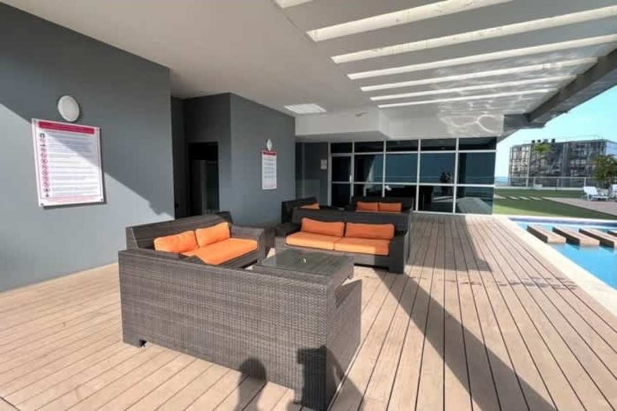 Studio bedroom space with floor-to-ceiling window offering Pacific Ocean view in PH Colores Bella Vista Panama