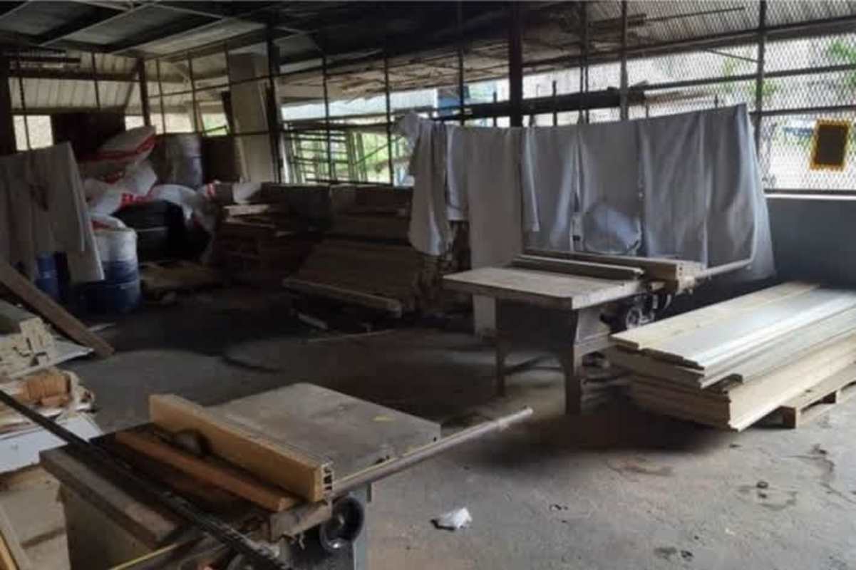 Workshop area inside warehouse with industrial equipment and timber storage Tocumen Panama