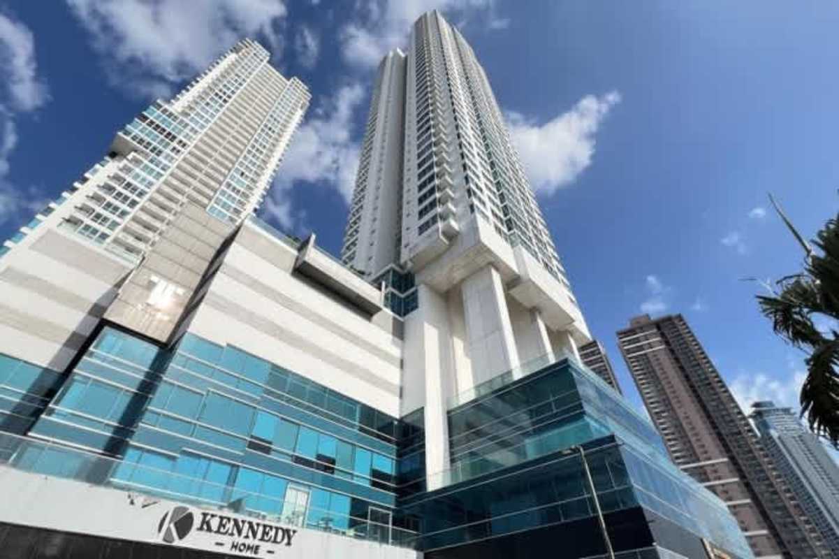 Bedroom with large corner floor-to-ceiling windows and city views in PH Top Towers Costa del Este Panama