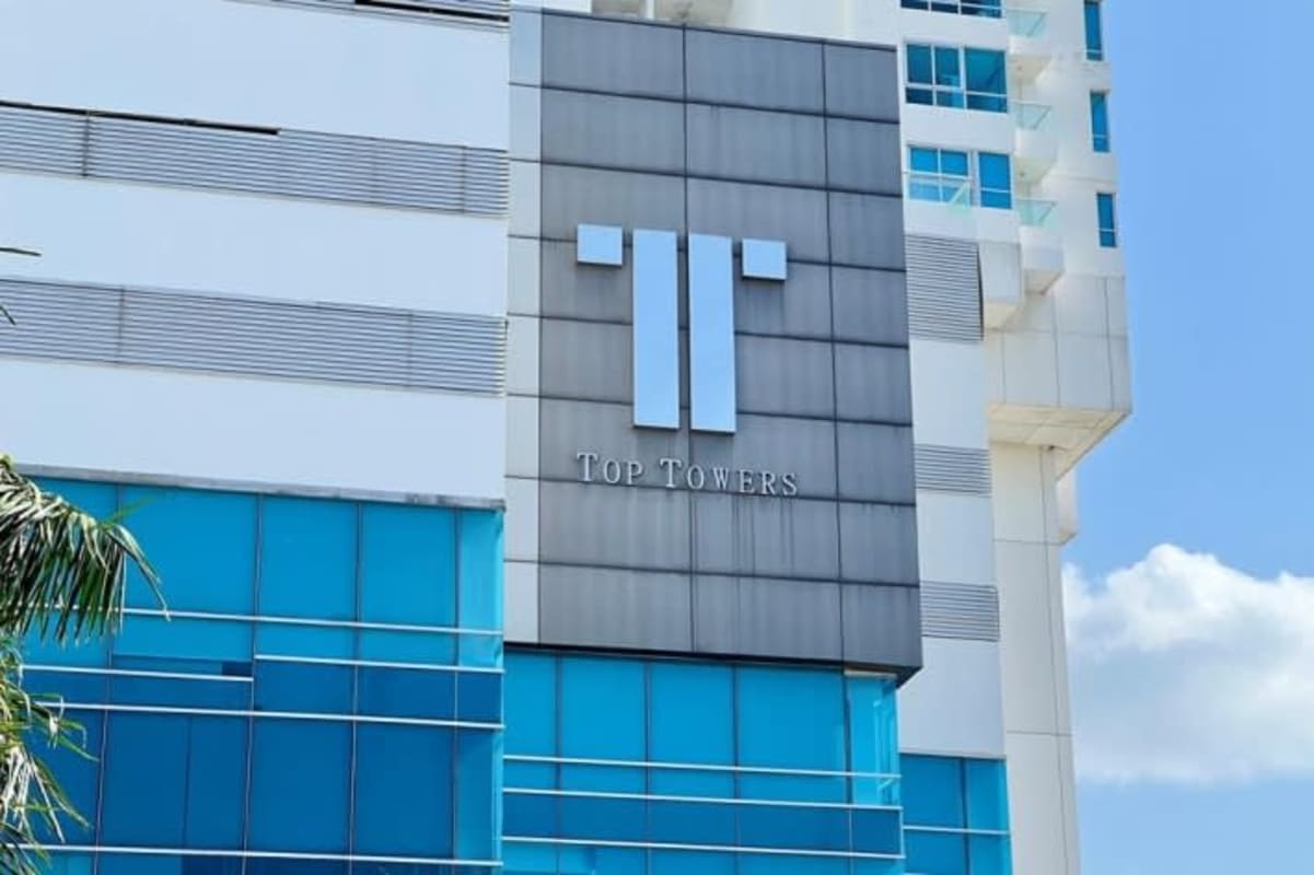 Open modern living room in apartment with panoramic windows and balcony exit in PH Top Towers Costa del Este Panama City