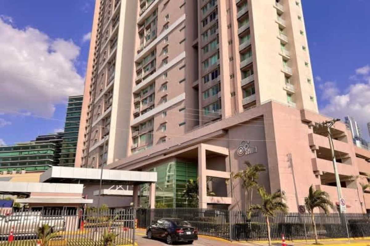 Modern high-rise with secure gated entrance balconies palm trees PH Sevilla Panama