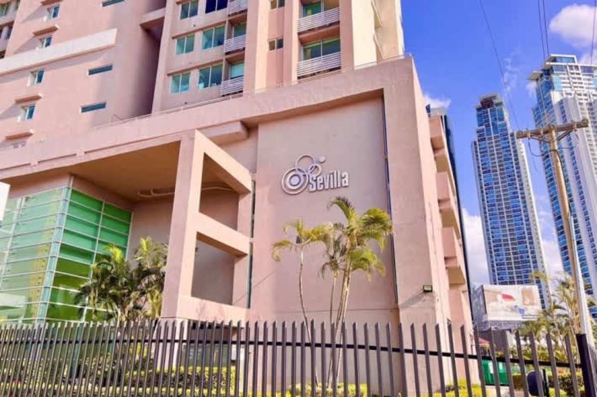 Exterior glass high-rise building Sevilla signage palm trees Costa del Este Panama