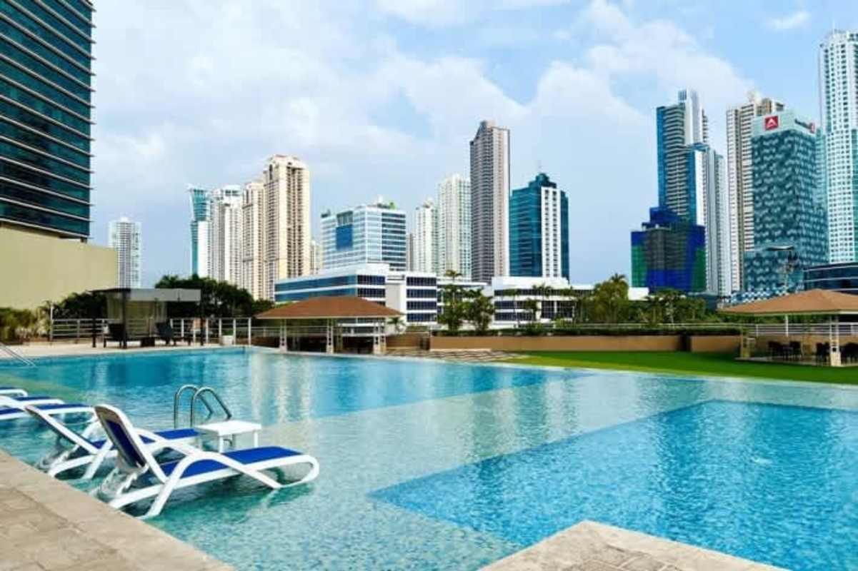 Luxury apartment complex with infinity pool poolside seating pergolas skyline view PH Sevilla Panama