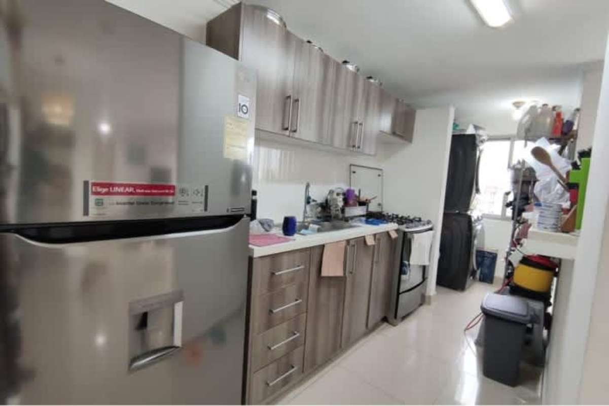 Modern kitchen with quartz countertop, wooden cabinets, laundry area in PH Ibiza Río Abajo