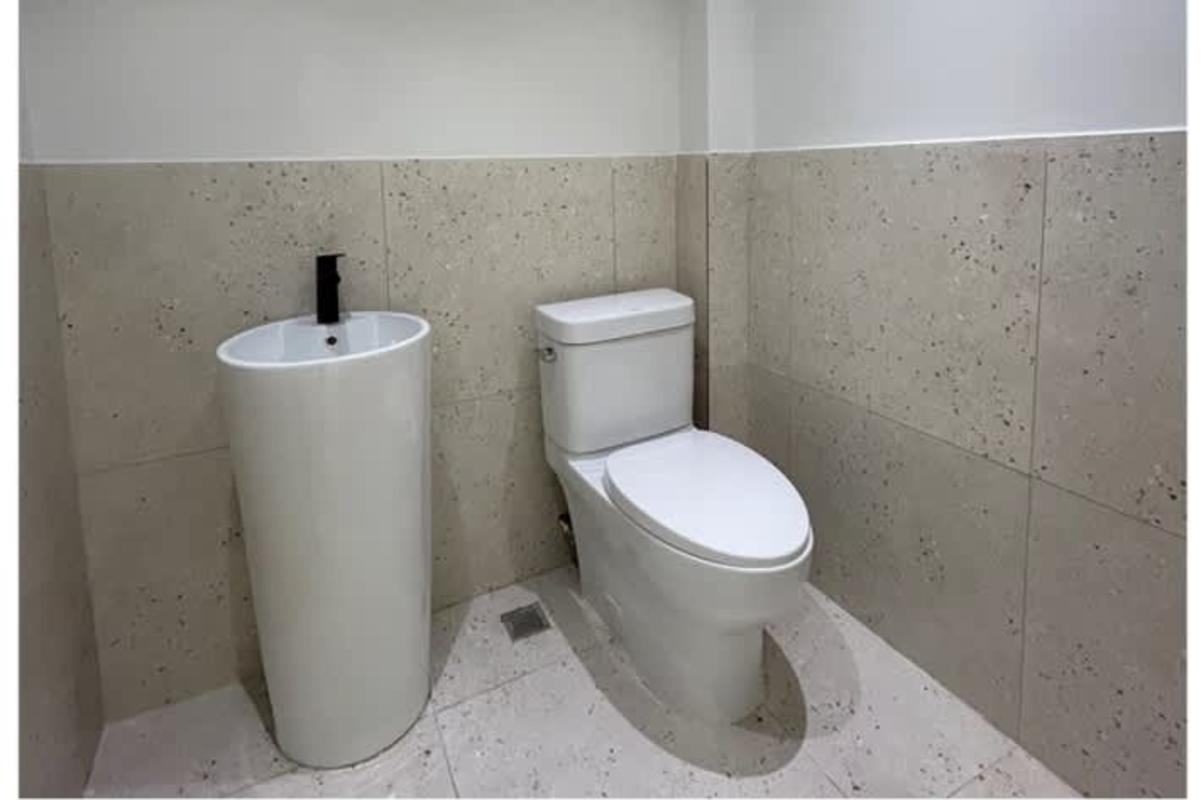 Contemporary conference room with LED lighting, white table, black chairs in PH Prime Tower Costa del Este Panama