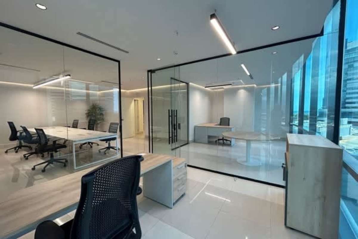 Modern open-concept office area with glass partition walls and natural lighting in Prime Tower Costa del Este Panama