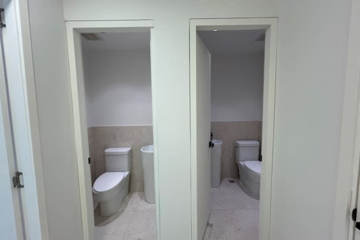 Minimalist commercial bathroom with pedestal sink and toilet in PH Prime Tower Costa del Este Panama