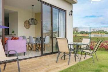 Covered patio area with garden and sliding glass doors in Riverview Costa Verde Panama